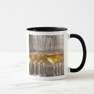 Mug deux rangées de verres à vin avec du vin blanc dou
