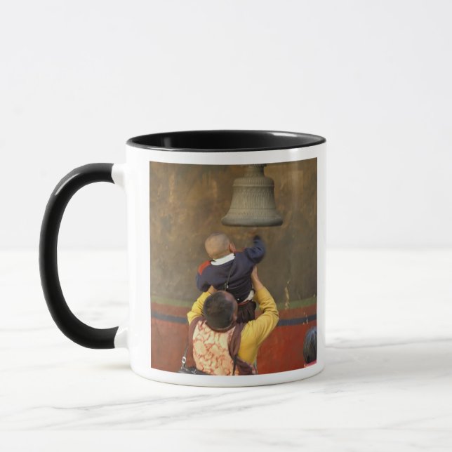 Mug moine bouddhiste tibétain soulevant un garçon pour (Gauche)