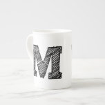 Mug monogrammé : Lettre "M"<br><div class="desc">Mug monogrammé avec la lettre "M" en noir.</div>