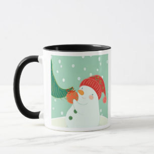 Mug Un bonhomme de neige accrochant un ornement sur un