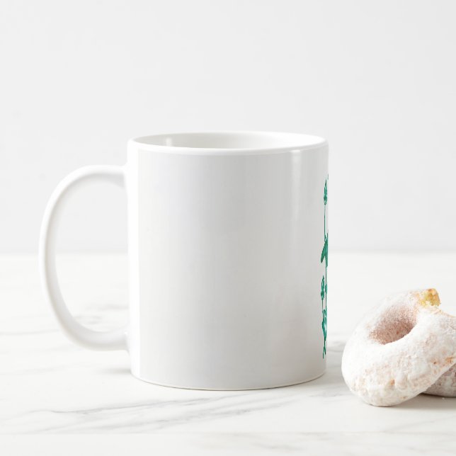 Mug un tableau d'une fleur et d'un poisson sur un doss (Avec donut)