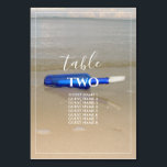 Numéro De Table Bouteille Sur La Plage Sable Mariages Nom<br><div class="desc">Ce design comprend une bouteille posée sur la plage. La belle couleur de la bouteille bleue contraste avec le sable doré, ce qui en fait un parfait assortiment. La bordure blanche et fine encadre parfaitement la bouteille bleue lavée sur le sable et correspond à la typographie moderne de couleur blanche....</div>