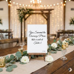 Numéro De Table Funny "You Survived the Ceremony" Minimalist Weddi<br><div class="desc">Add a touch of humor to your wedding reception with this witty table number card! Featuring the playful phrase "You Survived the Ceremony! Please take a seat at, " this minimalist design uses elegant black script calligraphy on a crisp white background. It's the perfect icebreaker for your guests. Easily personalize...</div>