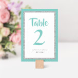 Numéro De Table Glittery Bat mitzvah Turquoise et Silver<br><div class="desc">Ce numéro de table Bat mitzvah branché présente une parties scintillant brillante en faux plan contre un arrière - plan de couleur solide. Utilisez le formulaire modèle pour ajouter vos propres informations. L'outil de conception peut être utilisé pour modifier le style de police,  la couleur et la disposition.</div>
