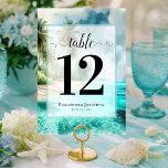 Numéro De Table Plage Tropicale avec Palmiers Mariage Élégant<br><div class="desc">Facilitez à vos invités la recherche de leurs tables avec ces jolies cartes de numéros de table. Le design élégant de thème côtier ou insulaire présente une calligraphie script élégante sur un fond d'aquarelle d'une plage tropicale avec des palmiers et des eaux turquoise. Les noms du couple et la date...</div>