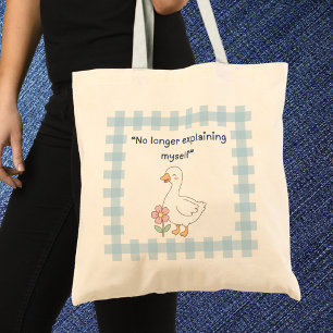 Oie drôle avec sac cabas à carreaux bleus