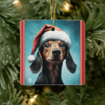 Ornement En Céramique Chien mignon portant le chapeau du Père Noël Dachs<br><div class="desc">Célébrez la saison des Fêtes avec notre adorable Ornement d'Arbre de Noël avec un mignon chien en dachshund portant un chapeau de Père Noël festif. Personnalisez le dos avec le nom et l'année de tout texte que vous souhaitez ajouter.</div>