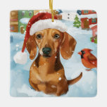 Ornement En Céramique Dachshund Winter Wonderland Christmas Joy<br><div class="desc">Ce design festif reflète l'esprit joyeux de la période des fêtes, avec un adorable petit portant un chapeau de Père Noël. Le chien est niché dans un pays des merveilles hivernales, avec un bonhomme de neige, un sapin de Noël décoré et des cadeaux joliment emballés. Les flocons de neige tombent...</div>