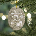 Ornement En Céramique Être un voyageur pas une carte touristique Typogra<br><div class="desc">Commémorez une année de voyage avec notre ornement de citation de typographie! Design présente la citation, "Be a Traveller, Not a Tourist" en typographie de monoline blanche ornée de deux illustrations de flèches, sur un arrière - plan d'un ton sépia vintage carte du monde 1708. Customisez le dos avec l'année....</div>