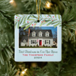 Ornement En Céramique First Christmas in Our New Home Greenery Photo<br><div class="desc">This beautiful holiday keepsake ornament features a photo of your new home with custom "First Christmas in Our New Home" script text, your family name, and the year the home was purchased. Design features modern watercolor winter greenery branches with green leaves and red berries. The light blue background color can...</div>