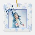 Ornement En Céramique Joy! Festive Baby Blue Snowflakes Christmas Photo<br><div class="desc">These beautiful Christmas ornaments make a wonderful gift or annual family memento. They feature a fun design with a photo surrounded by a white background with a festive array of pale or baby blue colored snowflakes. The back has space for a message or greeting as well as your signature and...</div>