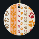Ornement En Céramique Paw Prints cute Dog Lovers<br><div class="desc">Design with a cute pattern of dog paw prints in orange and yellow and warm colours. This design looks as though a dog has walked over the product ! For dog lovers everywhere.</div>