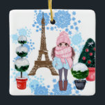 Ornement En Céramique Personalized Girl in Paris Winter Eiffel Tower<br><div class="desc">This beautiful Paris themed ceramic Christmas ornament design features a beautifully chic brunette girl wearing an adorable hat and scarf with the phrase "it's winter baby". The girl is standing amongst snow covered topiaries decorated for the Christmas holiday in front of the Eiffel Tower. The background for this ornament is...</div>