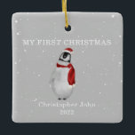 Ornement En Céramique Premier Noël Bébé Penguin Gris Neige<br><div class="desc">Illustration d'un pingouin portant un chapeau santa et un foulard assorti entouré de flocons de neige avec un arrière - plan gris. Le texte dit,  "Mon premier Noël." Personnalisez le nom et l'année.</div>