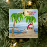 Ornement En Céramique Santa Claus Sandman Sur La Plage Tropicale<br><div class="desc">Mignonne sandman portant un casquette du Père Noël sur le sable de plage avec des lumières de vacances dans les palmiers. Le texte peut être modifié ou supprimé.</div>
