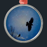 Ornement En Métal Winter Sky<br><div class="desc">A crow bravely fly through a blue,  snow filled winter sky as a perched crow looks on. This is a nice winter or Christmas ornament for a nature lover.</div>