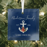 Ornement En Verre Nautical Lake House Winter Floral Navy Blue<br><div class="desc">Stylish Script Nautical Lake House Family Name Navy Blue Glass Ornament. Anchor topped with Watercolor Floral including red poinsettias,  pine cones and other beautiful winter greenery.</div>