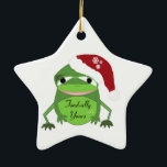 Ornement Étoile En Céramique Drôle crapaud dans un chapeau de Père Noël<br><div class="desc">Un dessin humoristique pour quelqu'un qui aime les froggies. Un crapaud vert avec une grande bouche portant un chapeau de santa rouge et blanc. Il dit que le message "toadally your" peut être modifié comme souhaité.</div>