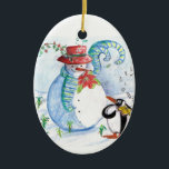 ORNEMENT OVALE EN CÉRAMIQUE LA SÉRÉNADE HIVERNALE DE SNOWMAN ET PENGUIN<br><div class="desc">Peinture originale couleur pastel en bleu blanc,  bonhomme de neige et pingouin jouant du violon dans la neige hivernale avec des fleurs rouges,  fleurit.par Bulgan Lumini (c)</div>