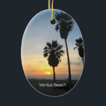 Ornement Ovale En Céramique Venice Beach California Sunset Souvenir<br><div class="desc">Cette image photographique montre de grands palmiers en silhouette debout contre un magnifique coucher de soleil jaune, doré, orange et rouge sur l'océan Pacifique à Venice Beach, Californie. Ajoutez du texte en option ou vos dates de vacances pour un souvenir unique. Autre design exclusif original par Sonja Quidama Image Code...</div>