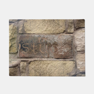 Paillasson "Je suis coincé" une autre brique dans le mur