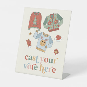 Panneau de vote du concours de pull moche de Noël 