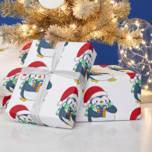 Papier Cadeau Penguin dans un casquette de Noël avec un cadeau