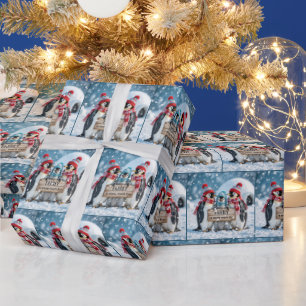 Papier Cadeau Penguins de famille de Noël avec un panneau en boi