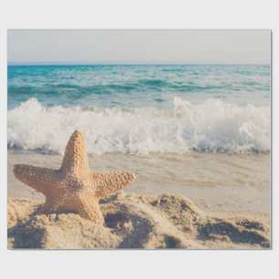 Papier Cadeau Starfish sur une plage de sable Photo