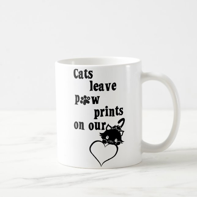 Pawprints de congé de chats sur notre tasse de (Droite)