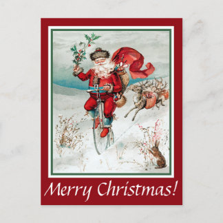 Père Noël à vélo avec carte postale lapin et renne