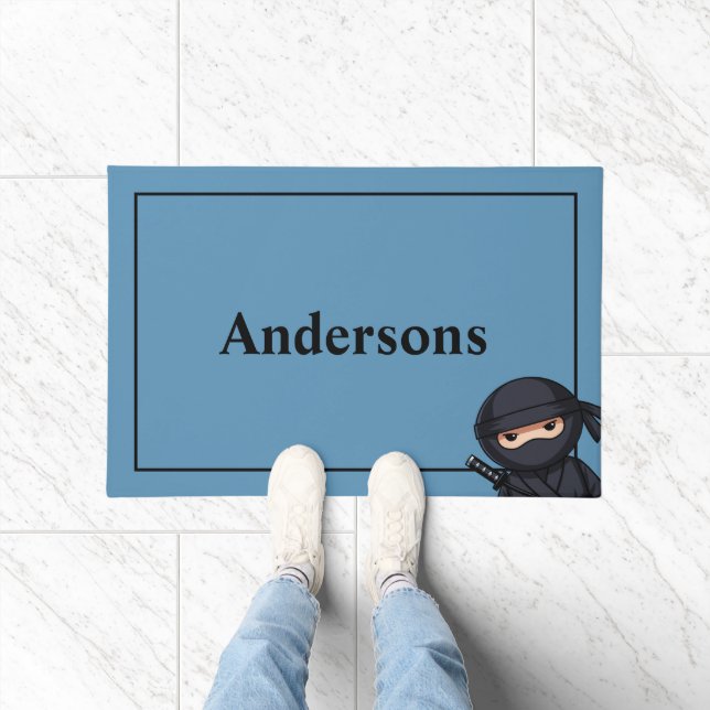 Petit guerrier ninja sur tapis de porte bleu (Intérieur)
