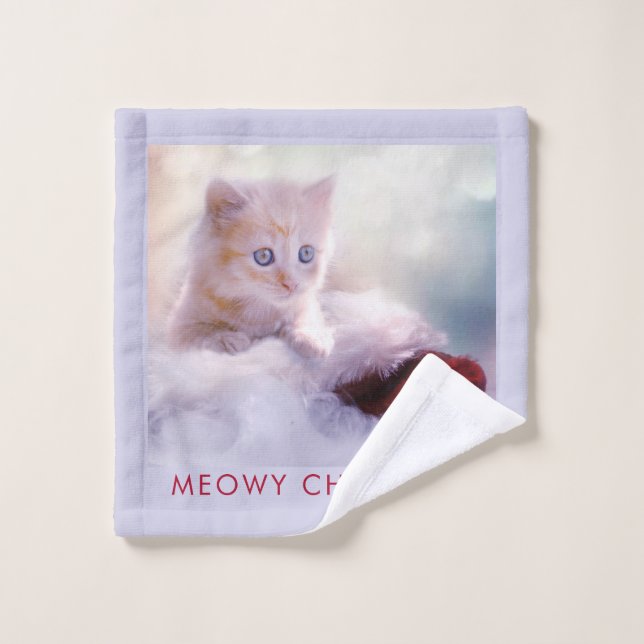 Petit Kitten reposant sur un chapeau de Noël Meowy (Gant de toilette)