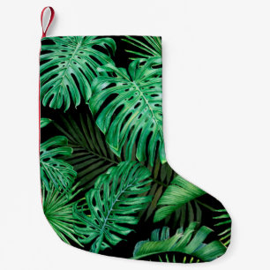 Petite Chaussette De Noël Motif sans couture avec feuilles tropicaux sur un