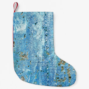 Petite Chaussette De Noël Mur de béton texturé, taches de rouille.
