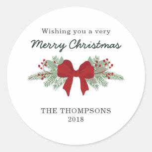 Pin et étiquette rouge de cadeau de Noël de ruban