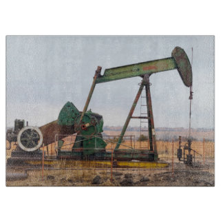Planche À Découper Grosse valet verte dans un champ pétrolifère