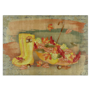 Planche À Découper Parapluie, bottes de pluie avec feuilles orange d'