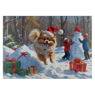 Planche À Découper Pomeranian courant dans la neige avec un chapeau d