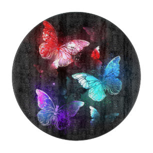 Planche À Découper Trois papillons lumineux sur fond de nuit