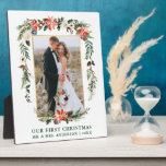 Plaque Photo Our First Christmas Watercolor Poinsettia Photo<br><div class="desc">Elegant Watercolor Poinsettias Our First Christmas Newlywed Wedding Photo Plaque includes beautiful watercolor red poinsettias,  botanical greenery,  winter foliage,  holly berries,  white roses,  cotton,  pine cones and blue berries.  Gold Frame. Green Text.</div>