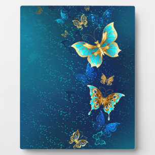 Plaque Photo Papillons d'or sur un Arrière - plan bleu