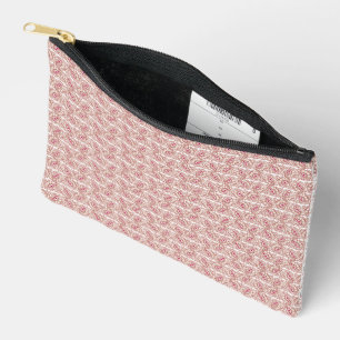 Pochette À Accessoires Tissus rouges et roses posés sur un tapis à motif
