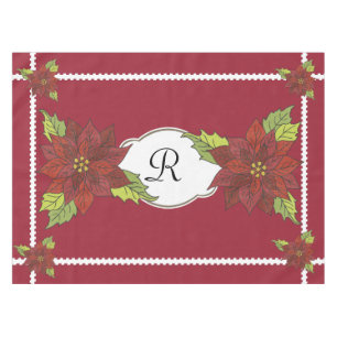 Poinsettias de monogramme sur la nappe rouge de