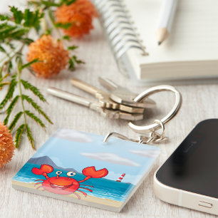 Porte-clefs Crabe heureux sur la plage avec un phare