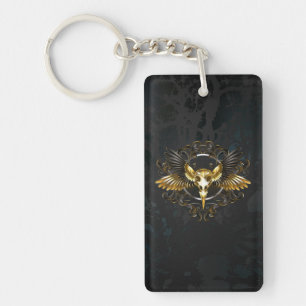 Porte-clefs Crâne d'oiseau doré sur fond noir