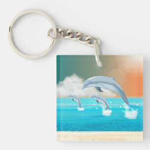 Porte-clefs dauphins faisant des sauts dans l'océan          