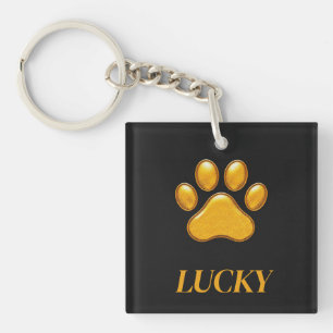 Porte-clefs Empreinte de patte dorée sur fond noir