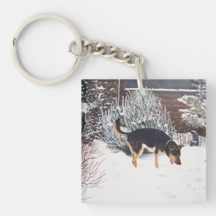 Porte-clefs Enneigement hivernal avec un mignon chien noir et