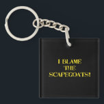 Porte-clefs Funny Scapegoat Quote A Bold Statement on Blame<br><div class="desc">This striking image delivers a punchy message—"I BLAME THE SCAPEGOATS!"—in distressed yellow stencil text against a stark black background. It's a satirical take on the human tendency to deflect responsibility,  making it perfect for social commentary,  humor,  or protest-themed content. #BlameCulture #SatireArt #ScapegoatStatement #BoldTypography</div>